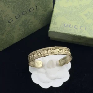 Alternative view of 18k Yellow gold plated GG slip on bangle with engraved details and gg logos