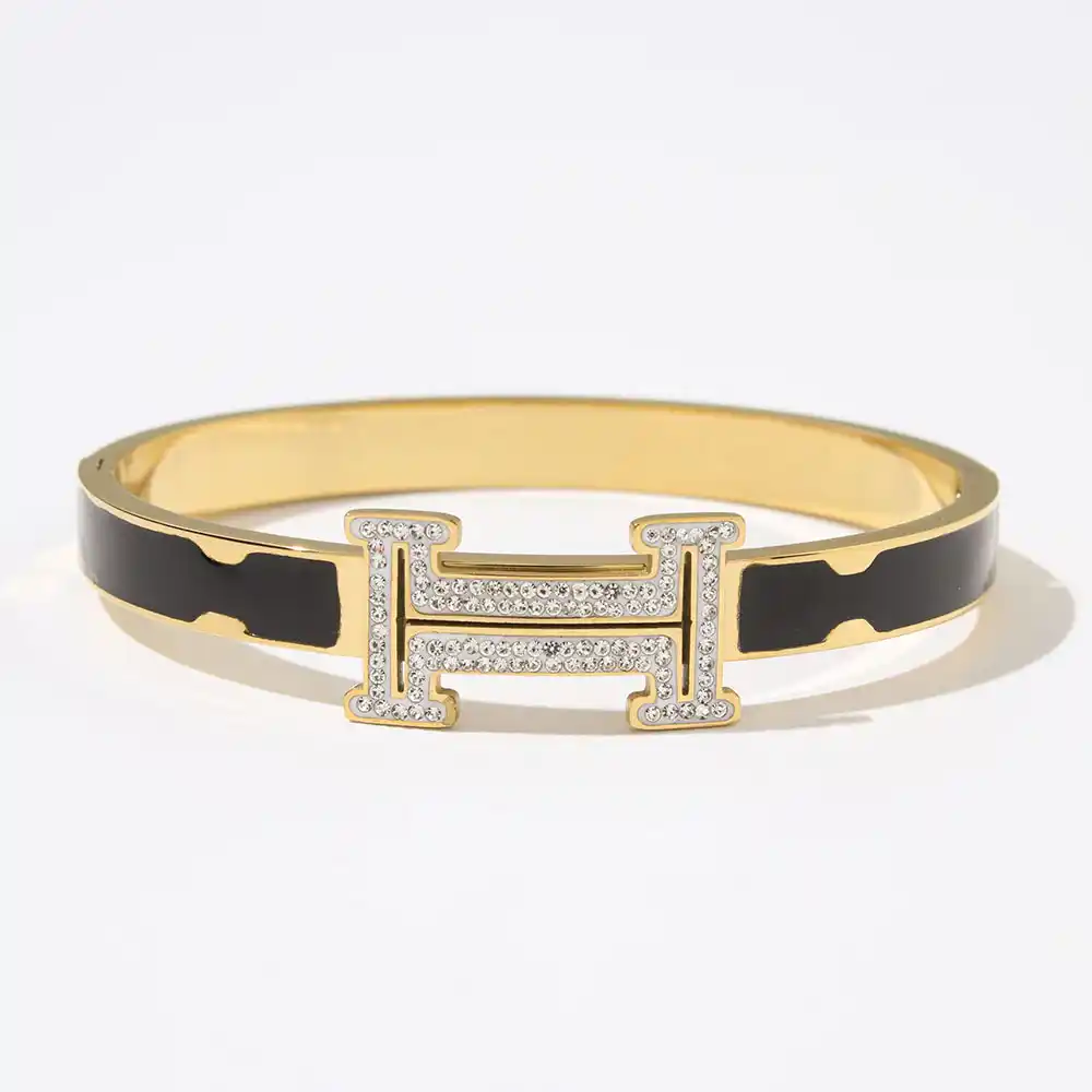 18k Yellow gold plated HM bracelet with black strip and stones on logo