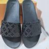 LV Black plain slip ons with embossed logos